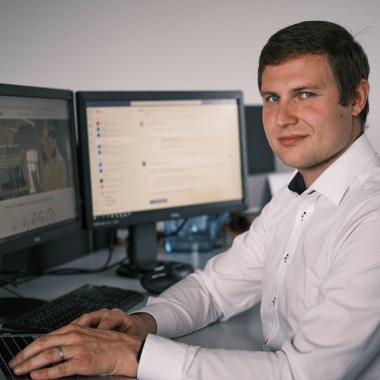 man sitting at computer