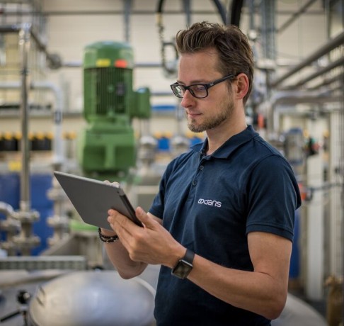 man in factory working on tablet