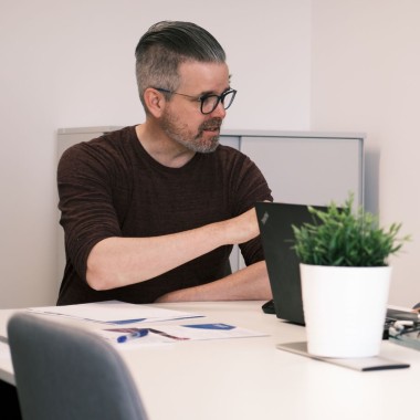 a man sitting at a table is talking to someone